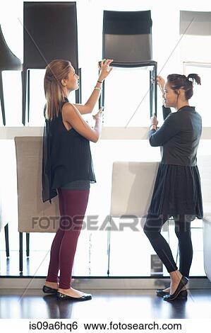Women shopping for chairs in store View Large Photo Image Stock Photograph - Women shopping for chairs in store. Fotosearch