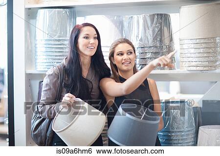 Women shopping for lamps in store View Large Photo Image Stock Photograph - Women shopping for lamps in store. Fotosearch