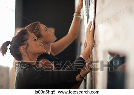 Stock Photography - Women shopping for mirrors in store. Fotosearch