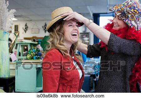 Women shopping in thrift store View Large Photo Image Stock Image - Women shopping in thrift store. Fotosearch