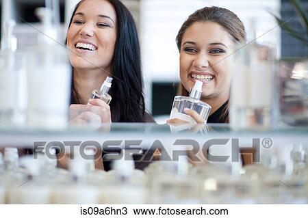 Stock Image - Women smelling soap in store. Fotosearch
