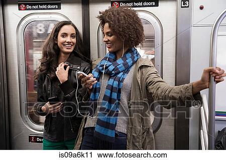 Women talking on subway View Large Photo Image Stock Image - Women talking on subway. Fotosearch