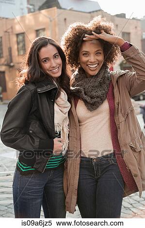 Stock Photography - Women walking together on city street. Fotosearch