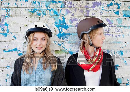 Stock Photo - Women wearing bicycle helmets. Fotosearch