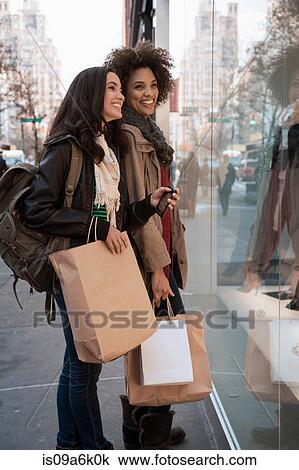 Women window shopping on city street View Large Photo Image Stock Image - Women window shopping on city street. Fotosearch