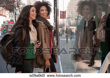 Women window shopping on city street View Large Photo Image Stock Image - Women window shopping on city street. Fotosearch
