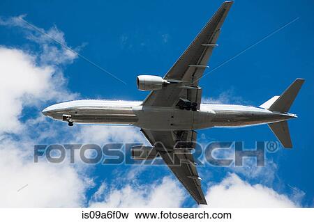 Stock Photo - Aeroplane in blue sky. Fotosearch
