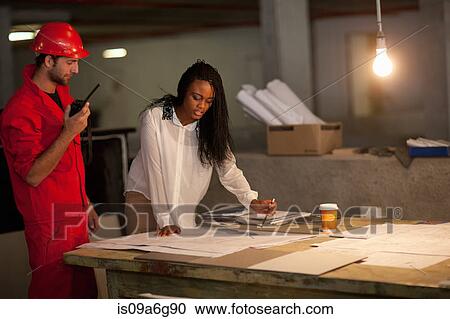Architect and building contractor discussing blueprints View Large Photo Image Stock Image - Architect and building contractor discussing blueprints. Fotosearch