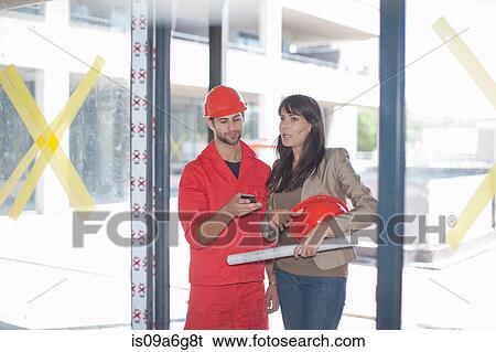 Architect and building contractor with smartphone View Large Photo Image Stock Photograph - Architect and building contractor with smartphone. Fotosearch