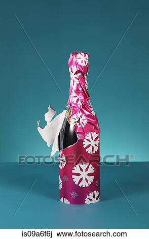 Bottle of bubbly wrapped in christmas paper View Large Photo Image Stock Image - Bottle of bubbly wrapped in christmas paper. Fotosearch