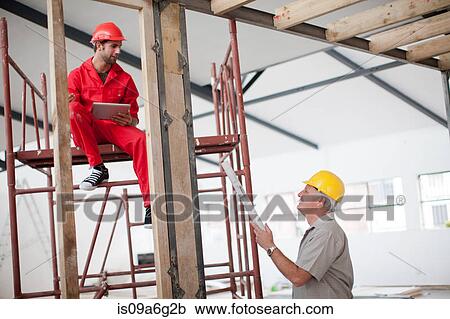 Builder and project manager with blueprint and digital tablet on construction site View Large Photo Image Stock Image - Builder and project manager with blueprint and digital tablet on construction site. Fotosearch