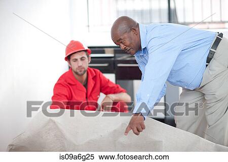 Stock Photography - Builder and project manager working on site. Fotosearch