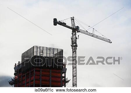 Stock Image - Building under construction with crane, New York City, USA. Fotosearch