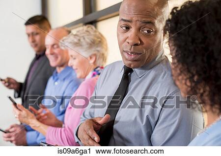 Stock Image - Business colleagues having discussion. Fotosearch