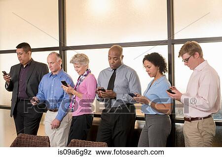 Business colleagues using cell phones View Large Photo Image Stock Photo - Business colleagues using cell phones. Fotosearch