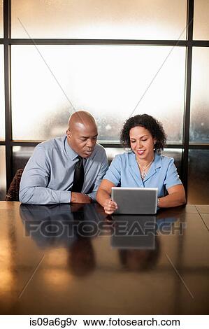 Business colleagues using digital tablet View Large Photo Image Stock Photo - Business colleagues using digital tablet. Fotosearch