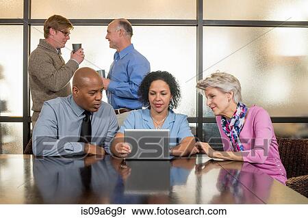 Business colleagues using digital tablet View Large Photo Image Stock Photography - Business colleagues using digital tablet. Fotosearch