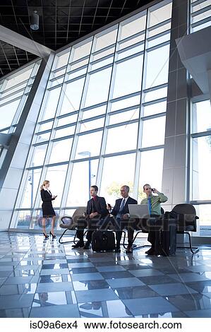 Picture - Businessman on cell phone using laptop. Fotosearch