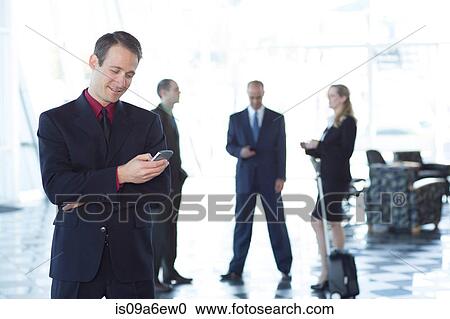 Stock Image - Businessman using cell phone. Fotosearch