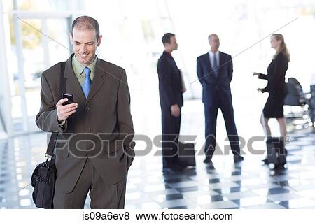 Stock Photo - Businessman using cell phone. Fotosearch