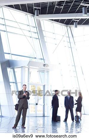 Stock Photo - Businessman using cell phone. Fotosearch