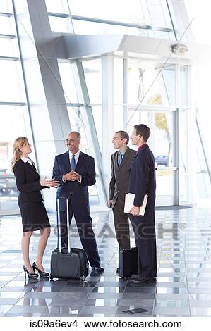 Businesspeople meeting in airport View Large Photo Image Picture - Businesspeople meeting in airport. Fotosearch