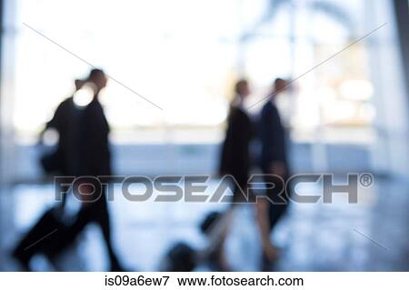 Businesspeople walking through airport, defocused View Large Photo Image Stock Photo - Businesspeople walking through airport, defocused. Fotosearch