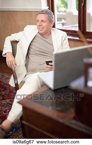 Casual business man in hotel room View Large Photo Image Stock Photo - Casual business man in hotel room. Fotosearch