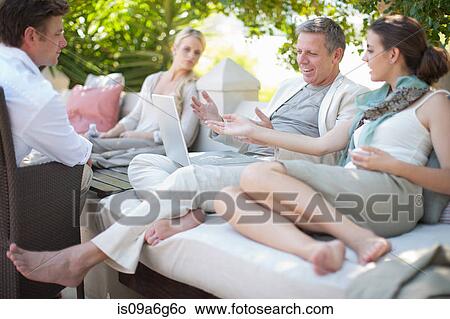 Casual business people on patio using laptop View Large Photo Image Picture - Casual business people on patio using laptop. Fotosearch