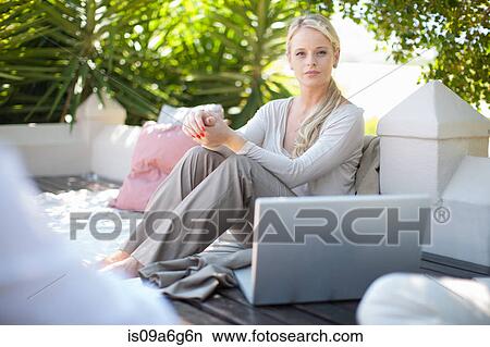 Casual business woman on patio with laptop View Large Photo Image Picture - Casual business woman on patio with laptop. Fotosearch