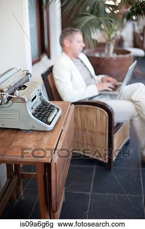 Casual businessman using laptop View Large Photo Image Stock Image - Casual businessman using laptop. Fotosearch