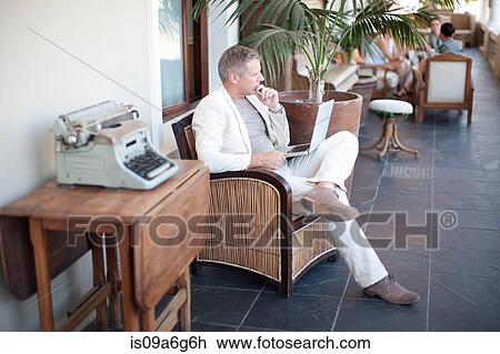 Stock Image - Casual businessman using laptop. Fotosearch