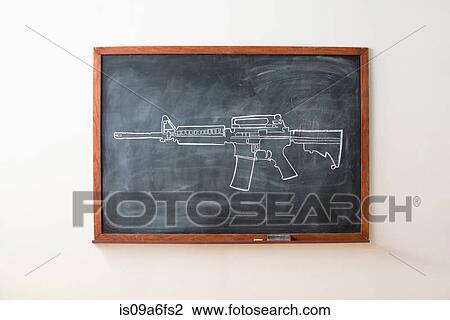 Stock Image - Chalk drawing of gun on blackboard. Fotosearch