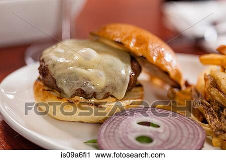 Stock Image - Cheese melted on burger. Fotosearch