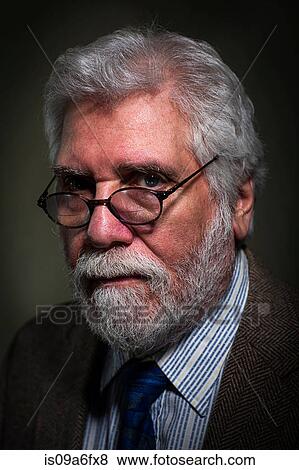 Stock Photo - Close up of senior adult male looking over spectacles. Fotosearch