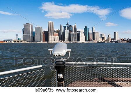 Stock Photography - Coin operated binoculars view Manhattan skyline, New York City, USA. Fotosearch