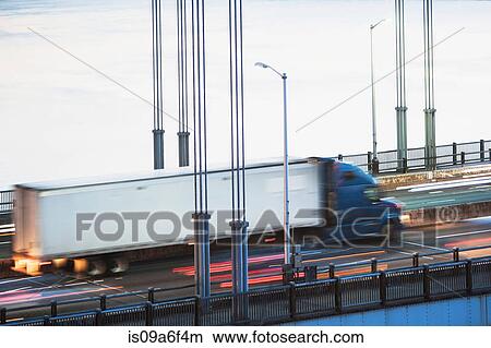 Picture - Container truck crossing bridge. Fotosearch