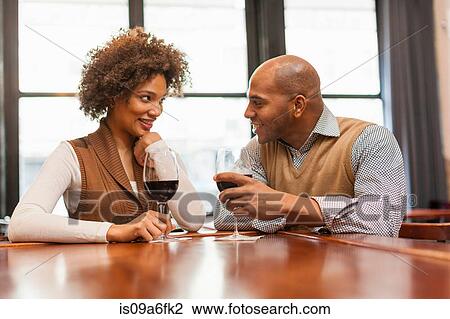 Stock Image - Couple at wine bar. Fotosearch