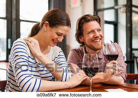 Stock Photo - Couple at wine bar. Fotosearch