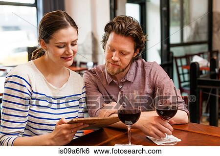 Stock Photograph - Couple at wine bar. Fotosearch