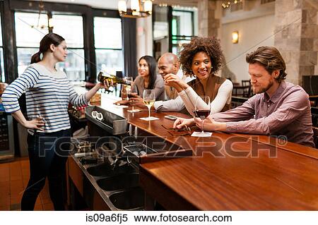 Customers drinking at bar View Large Photo Image Stock Photography - Customers drinking at bar. Fotosearch