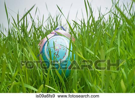 Stock Photo - Decorative easter egg hiding in grass. Fotosearch