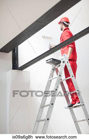 Decorator on ladder painting interior wall View Large Photo Image Stock Image - Decorator on ladder painting interior wall. Fotosearch