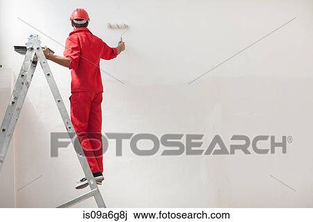 Decorator on step ladder painting white wall View Large Photo Image Stock Image - Decorator on step ladder painting white wall. Fotosearch