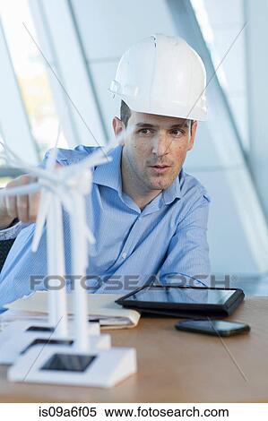 Engineer with model wind turbines View Large Photo Image Stock Photography - Engineer with model wind turbines. Fotosearch