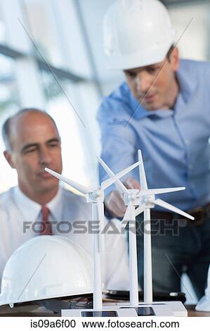 Stock Image - Engineers with model wind turbines. Fotosearch