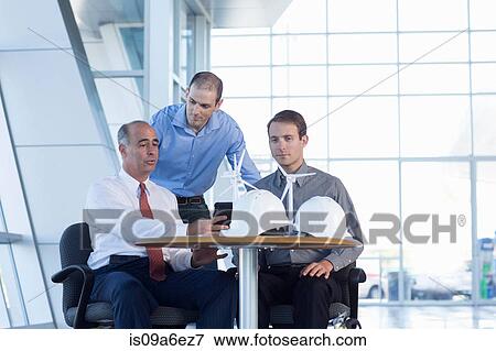 Engineers with model wind turbines View Large Photo Image Stock Photo - Engineers with model wind turbines. Fotosearch