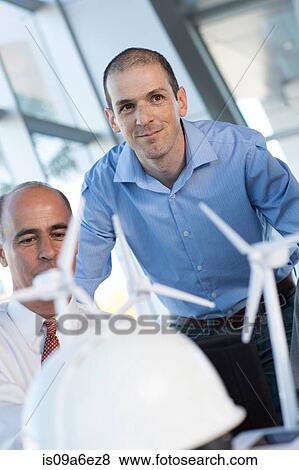 Engineers with model wind turbines View Large Photo Image Stock Photo - Engineers with model wind turbines. Fotosearch