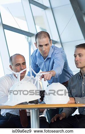 Stock Photo - Engineers with model wind turbines. Fotosearch