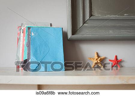 Envelopes and starfish on mantelpiece View Large Photo Image Stock Image - Envelopes and starfish on mantelpiece. Fotosearch